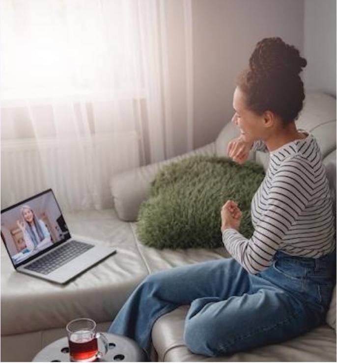 A woman attending an online counselling session from home